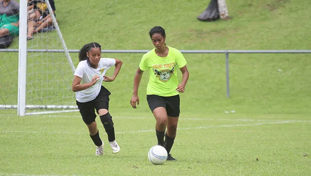 A Pago Youth defender, right, dribbles the ball out of danger against Utulei Youth