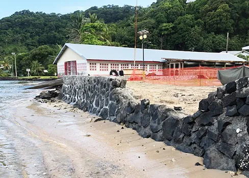 Rock wall going up on Utulei Beach behind DDW