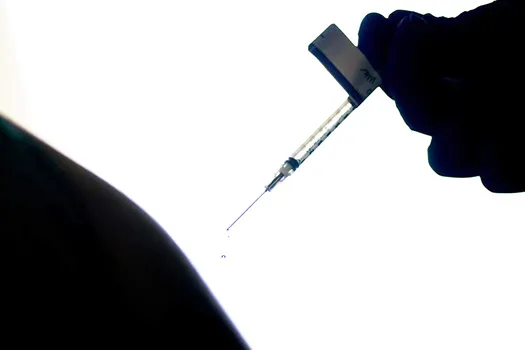 Droplet of vaccine dripping from needle