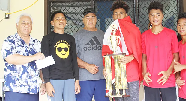 Members of the Vaiala Tongan Boys 13-15 team receive their championship trophy