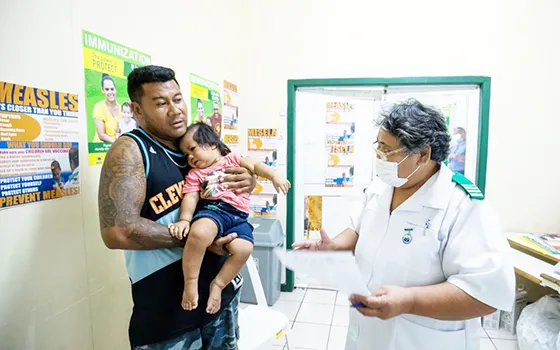 MAN WITH CHILD GETTING A VACCINATION
