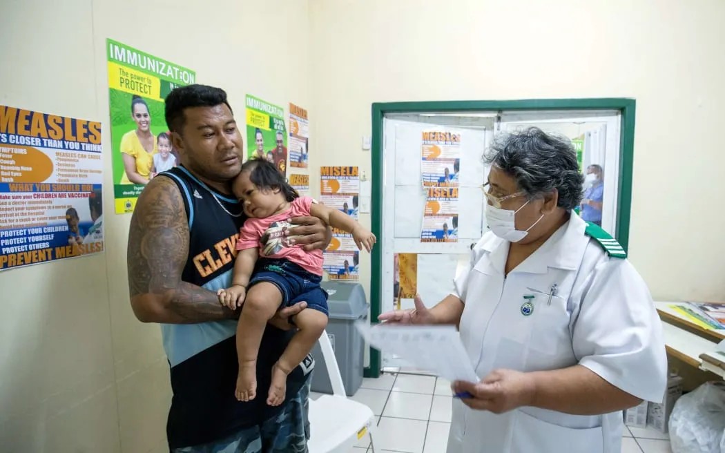 Dad with child getting vaccine
