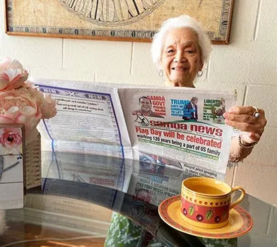Vera Annesley reading the paper