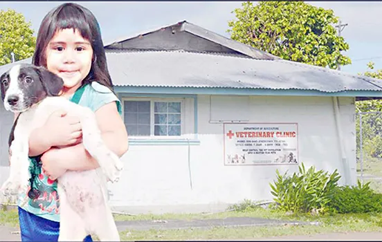 child with dog at vet clinic