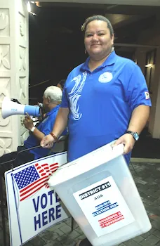 Woman carrying voting boxes