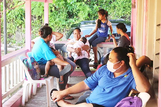 Members of the public talk outside the Faga’alu DOH Health Clinic