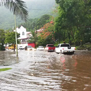 Vehicles trying to pass over a pool of water near Fatuoaiga