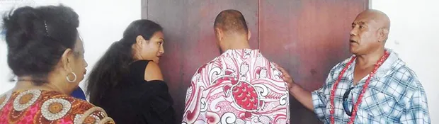 King Faipopo with his back to his supporters, seeks an explanation from his lawyer Josephine Sapolu