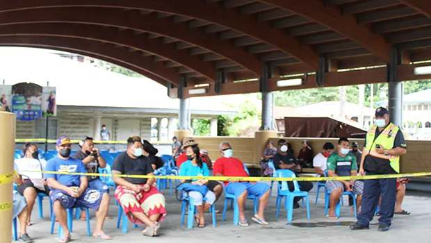 Inter-island wharf with people waiting for cargo under new system