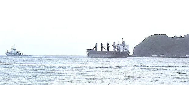 Wise Honest being towed by an off-island tugboat out of the harbor