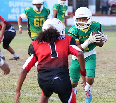 Misa Paiau of the JPS Lions is greeted by Vaouli of the JPS Vikings