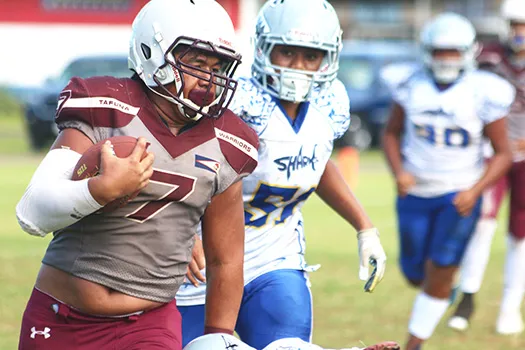 Tafuna Warriors ball carrier at the sidelines and