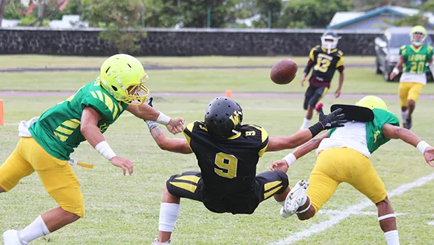 A pass from Jerry Isaako of the Wildcats intended for his wide receiver is broken up by Ben Tikeri