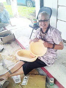 Andre Samoa with her kava bowls she carved