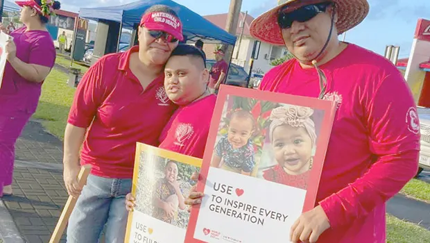 Famlies with signs at World Hearts Day wave
